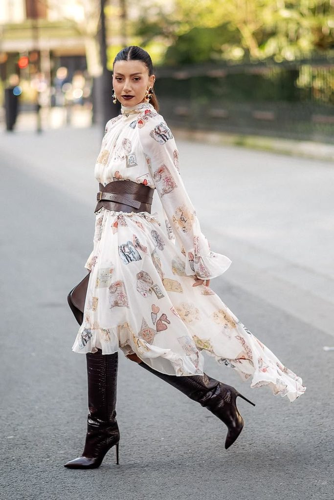 A Long-Sleeved Floral Dress With Knee-High Boots